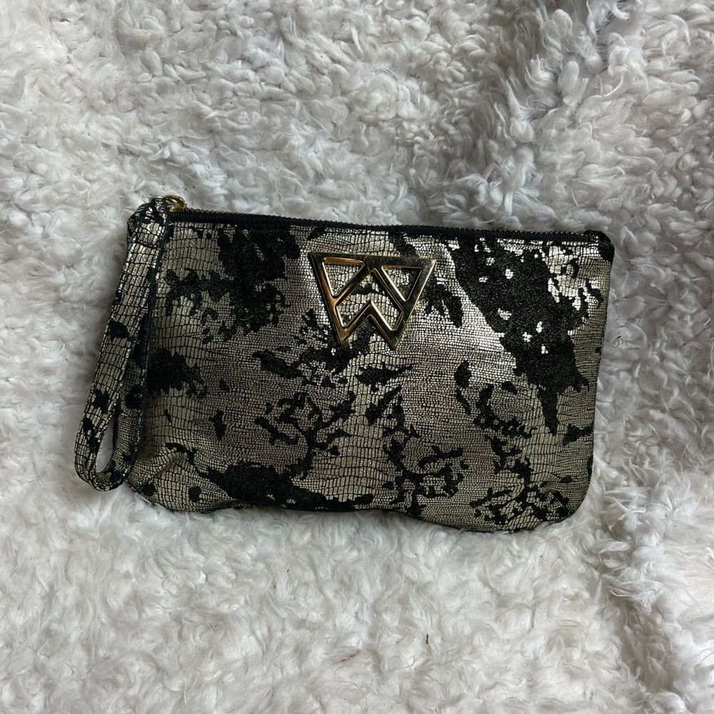 Kelly Wynne metallic gold and black wristlet with a gold tone logo accent